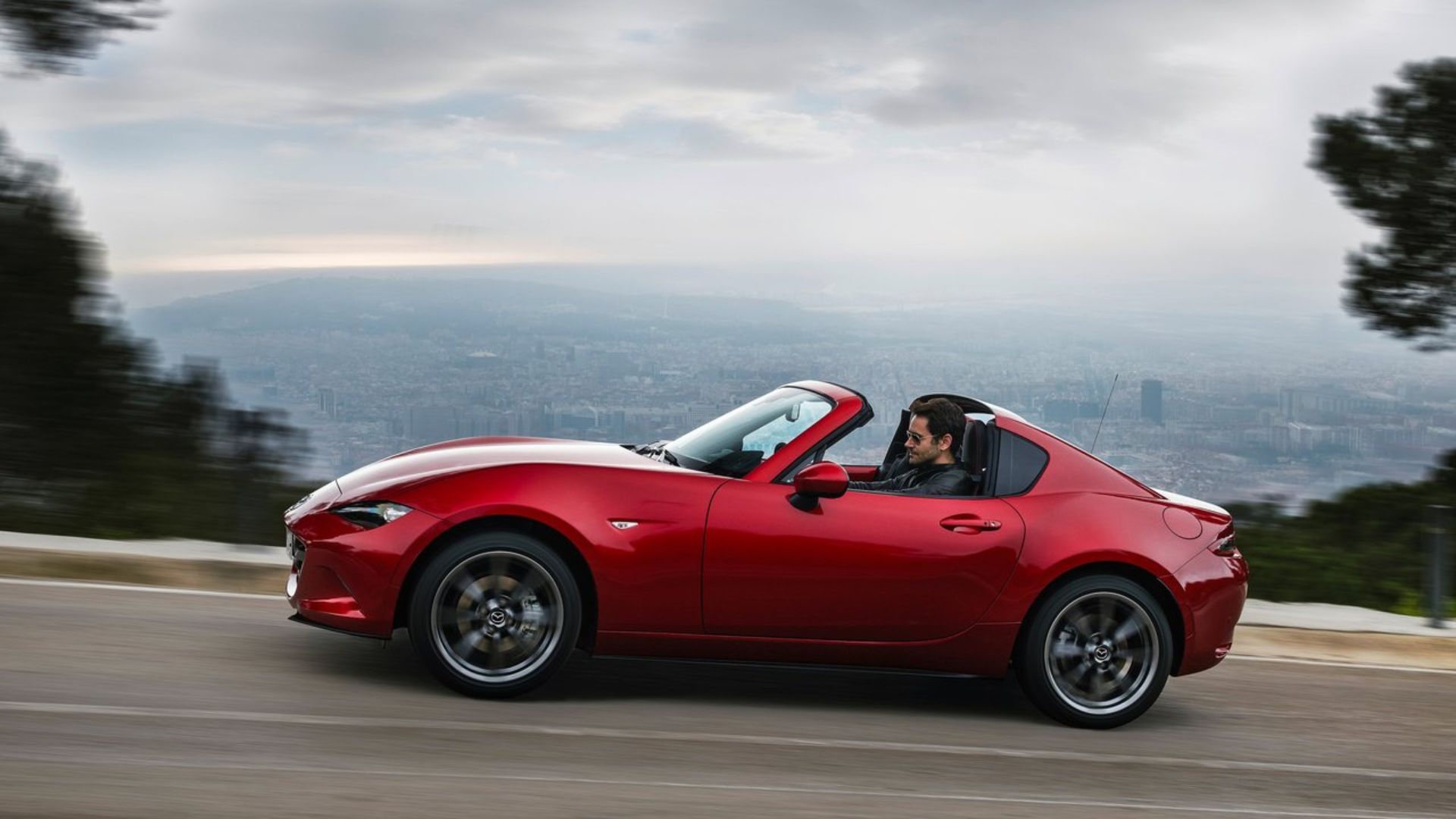 Dynamic side profile shot of a 2017 Mazda MX-5 RF.