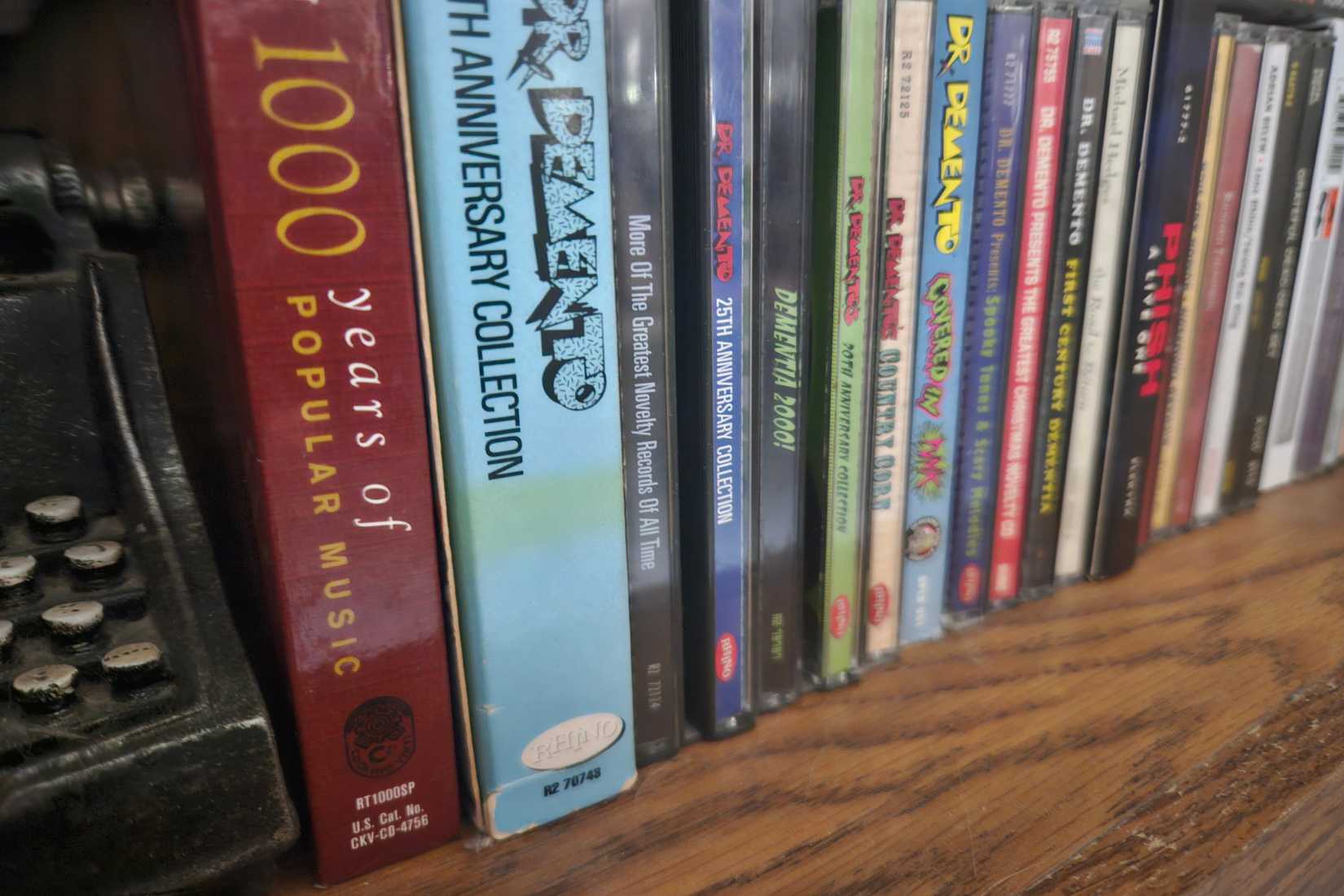 Several CDs line a shelf.