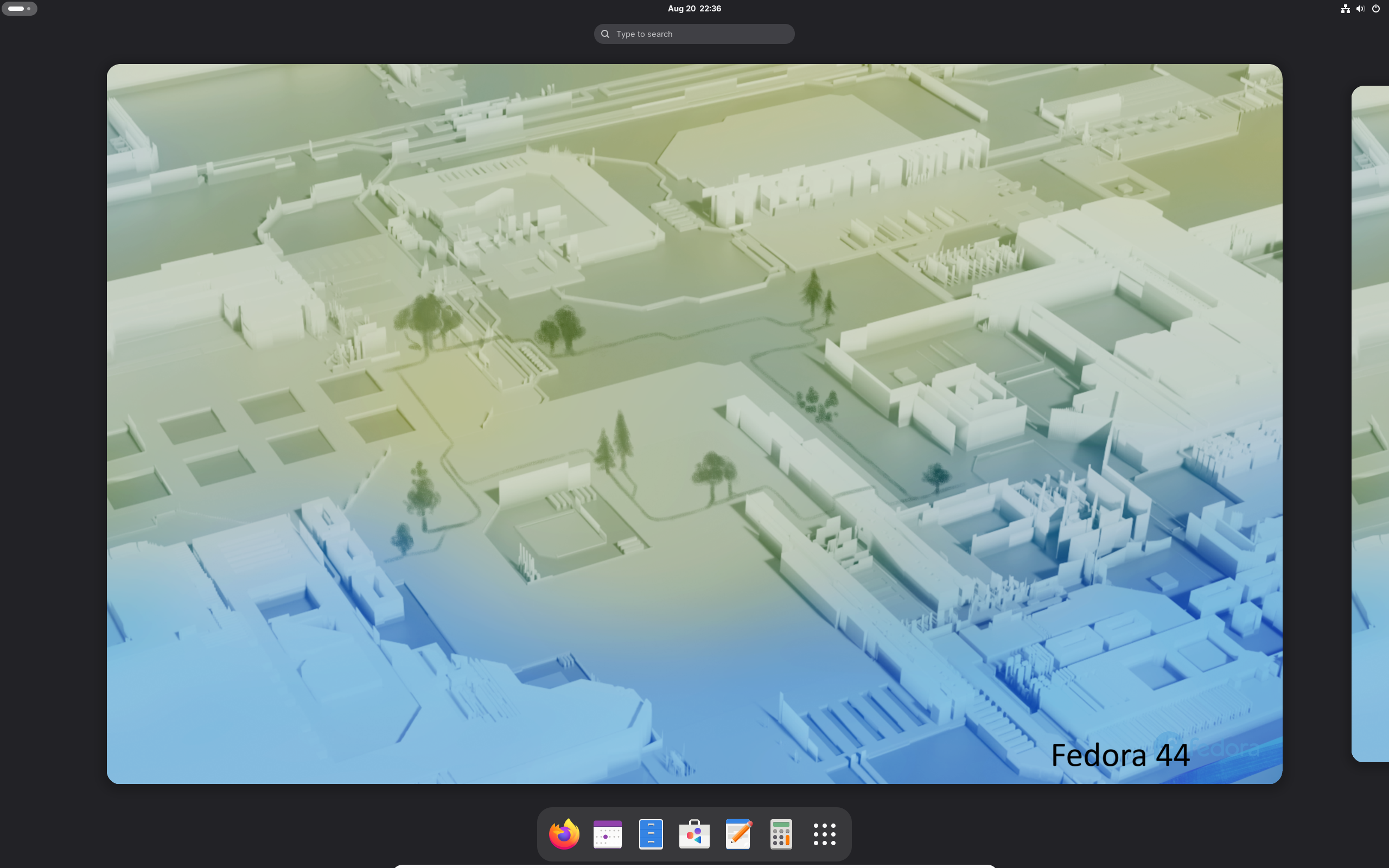 A screenshot of Fedora 44 running. The desktop is clean. No apps are running.