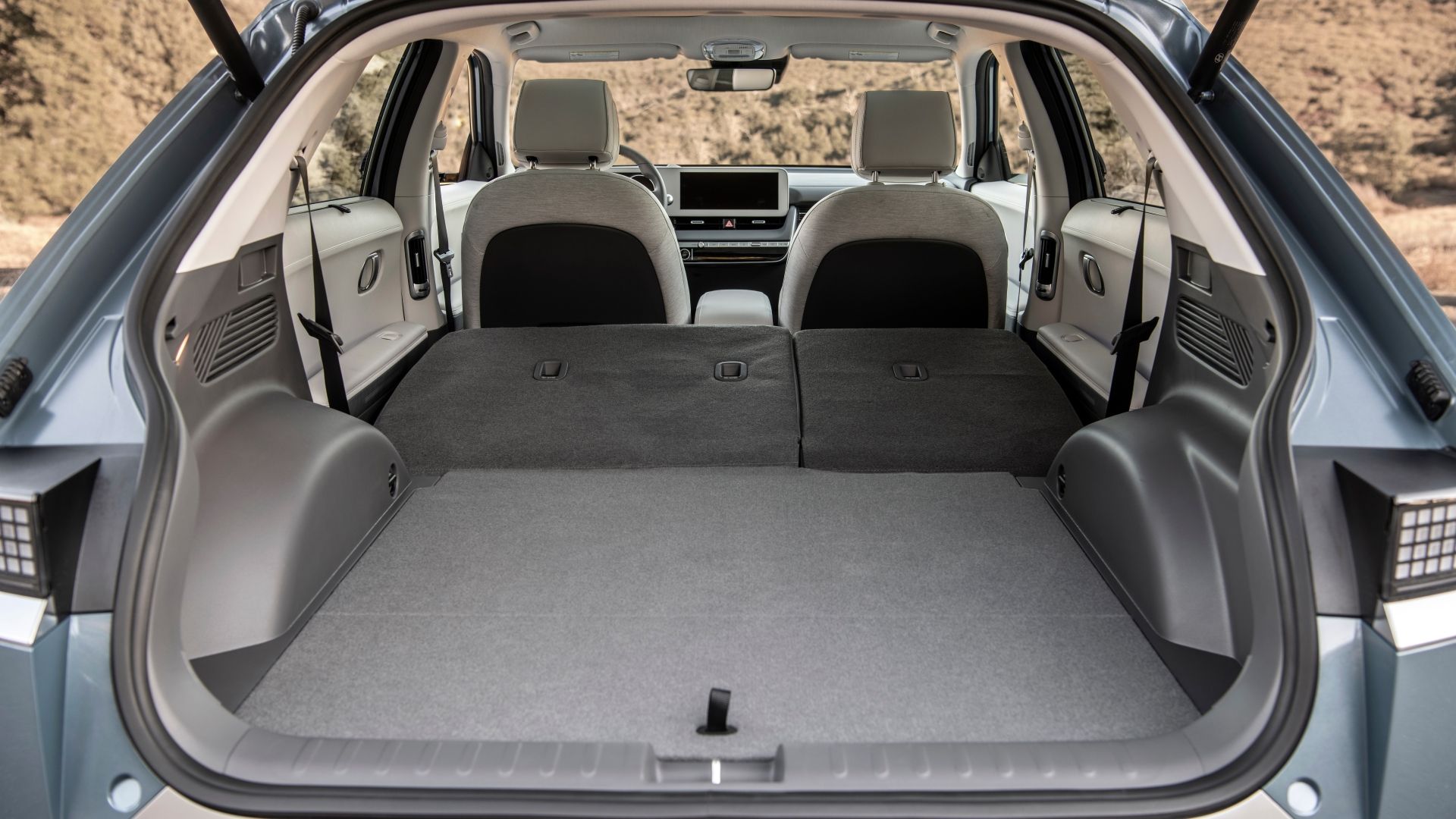 Shot of the open trunk of a 2022 Hyundai Ioniq 5 with the rear seats folded down