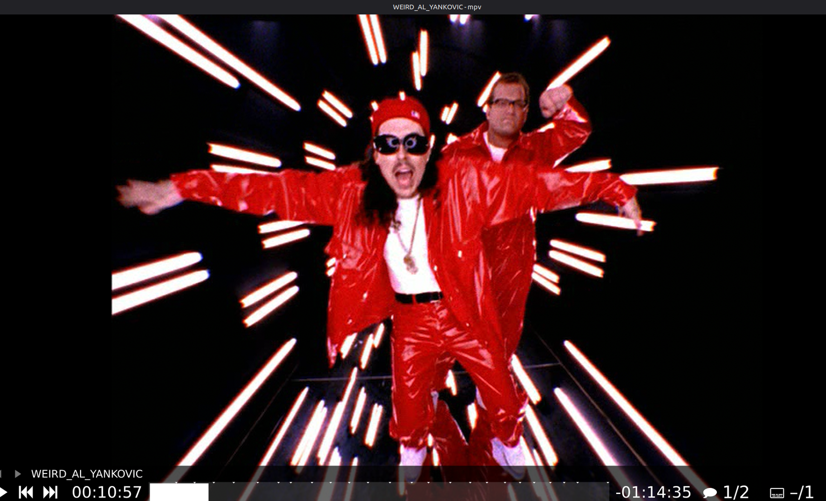 Two guys in red suits dance in music video being streamed on MPV.