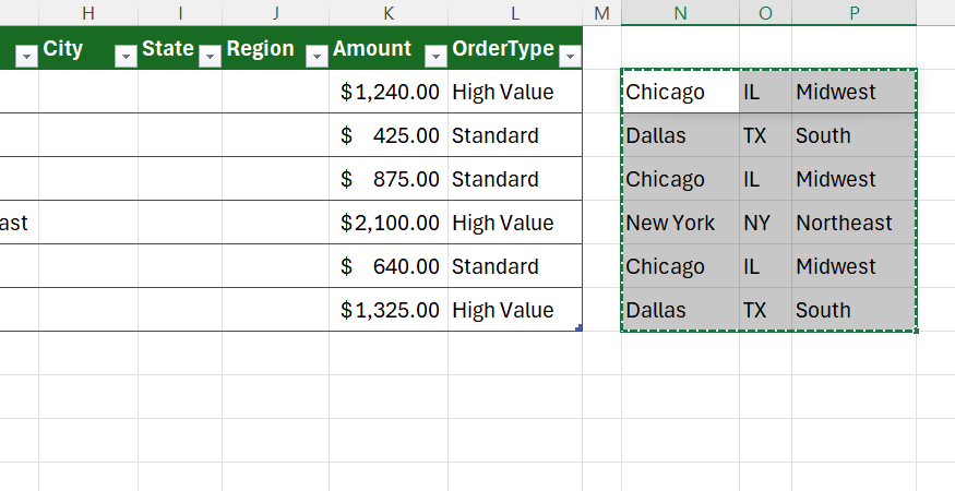 Cells containing city, state, an region outside an Excel table are copied, ready for insertion as values into the table.