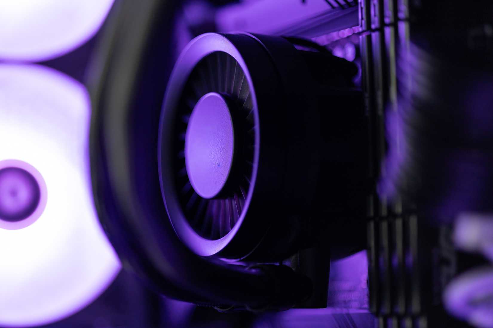 Close Up of Computer CPU Liquid Cooler Block with Neon Purple RGB Lighting.