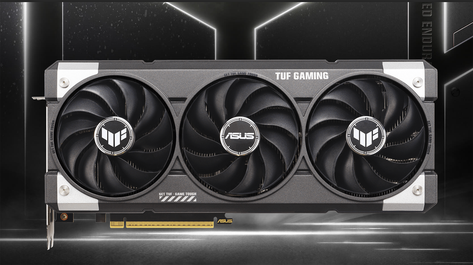 An ASUS TUF Gaming GeForce RTX™ 5060 Ti 16GB graphics card against a grey and silver background. 