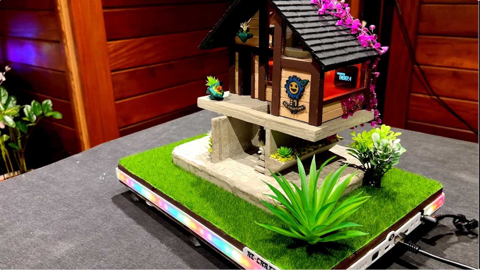 An old laptop motherboard repurposed as a Home Assistant server built into a scale model of a house.