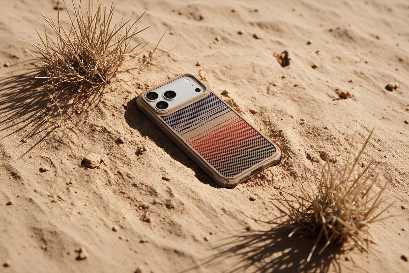 The PITAKA Cairn case lying on the sand.