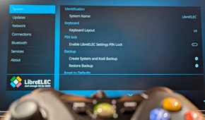 An XBOX controller in the foreground with LibreELEC in the background.