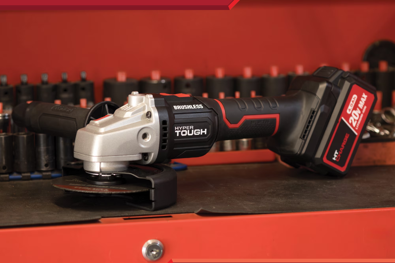 The Hyper Tough cordless angle grinder sitting on a workbench with sockets behind it.