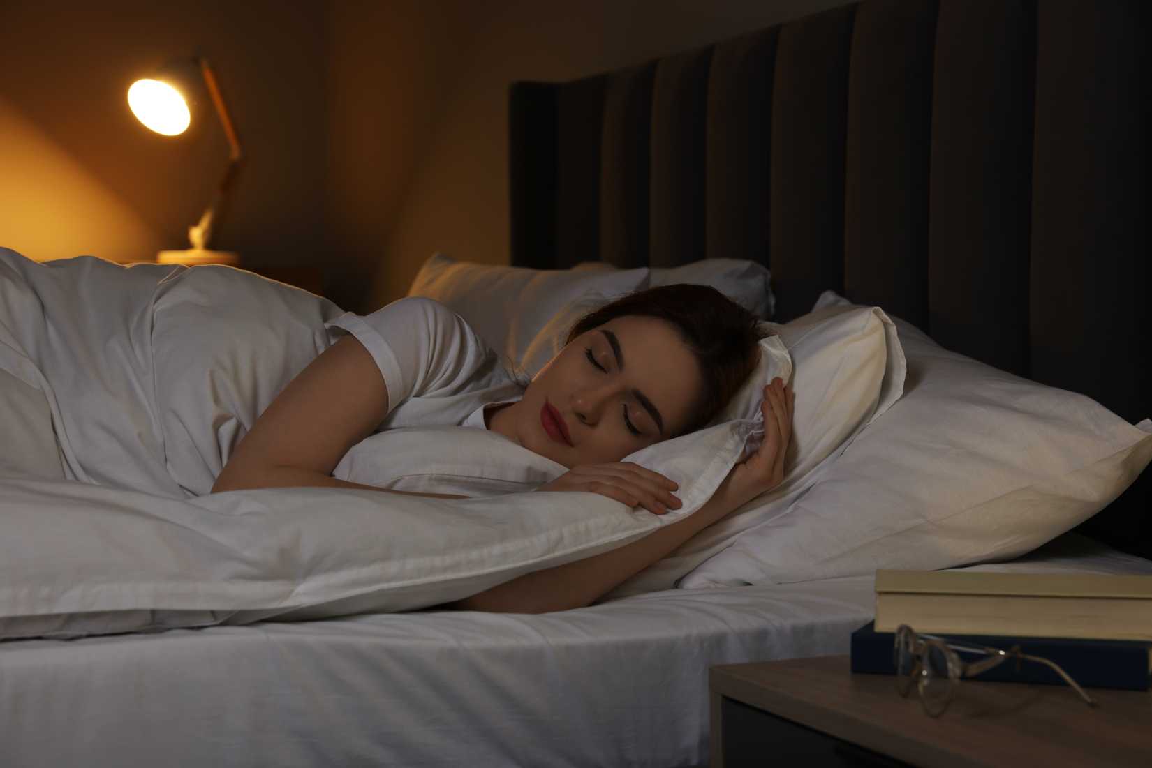 A woman is sleeping soundly in her bed.