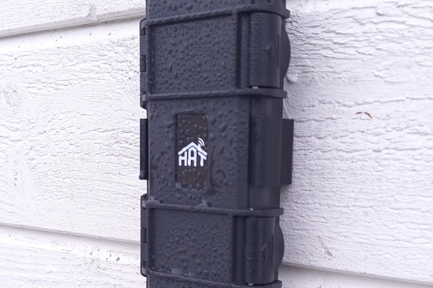 The HAT-Geiger ESP32 radiation sensor mounted on a wall.
