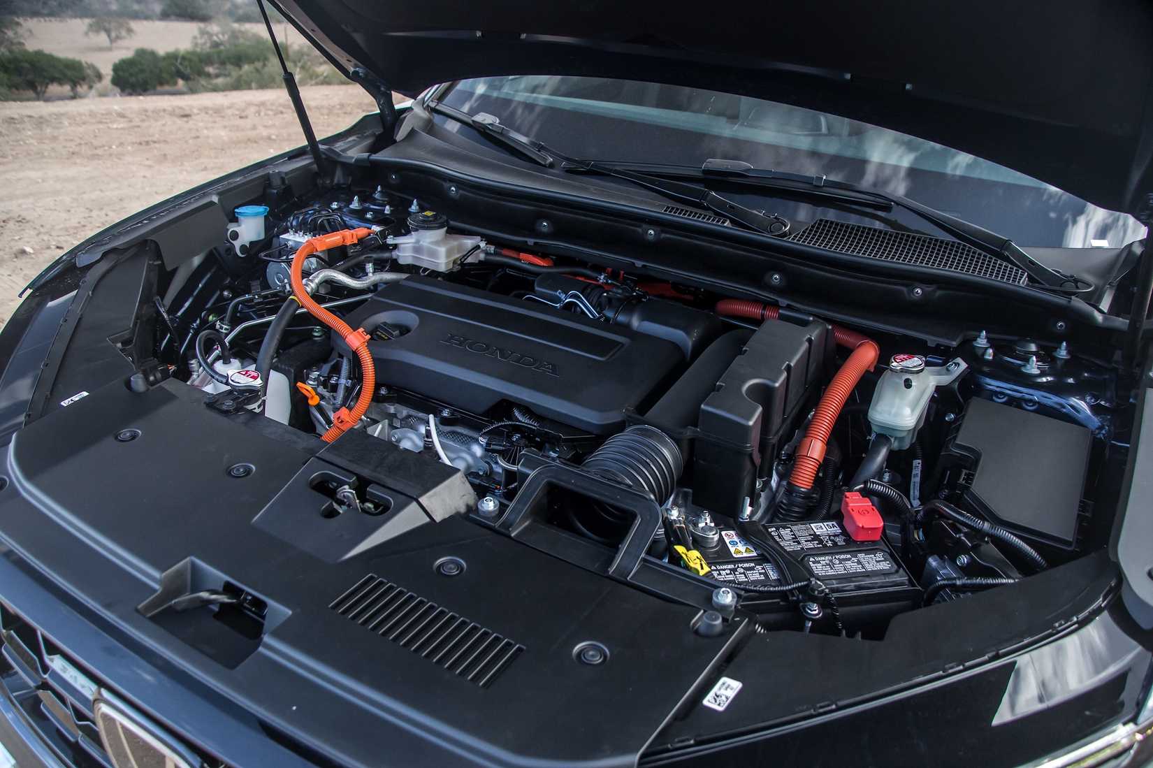 Shot under the hood of a Honda CR-V showing its hybrid engine.