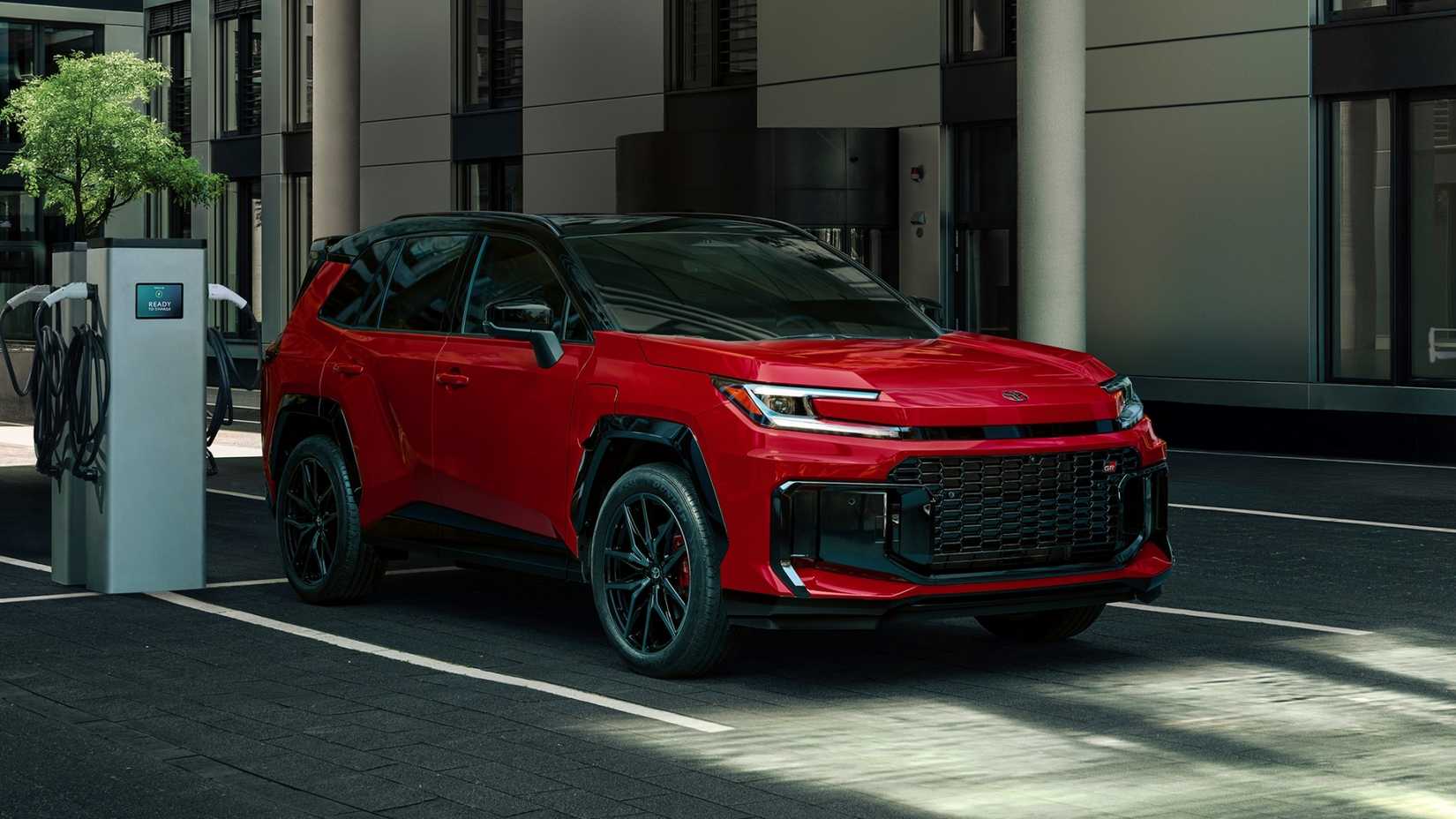 Static front 3/4 shot of a red 2026 Toyota RAV4 GR Sport.