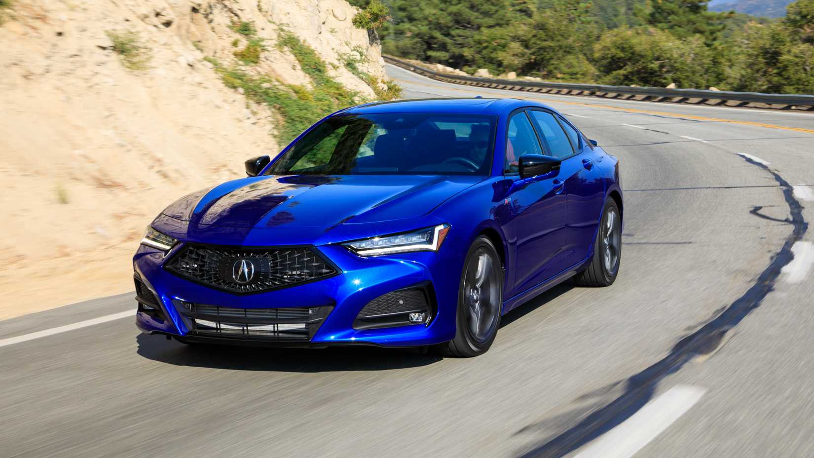2025 Acura TLX A-Spec Blue Front Angle Driving on Mountain Pass