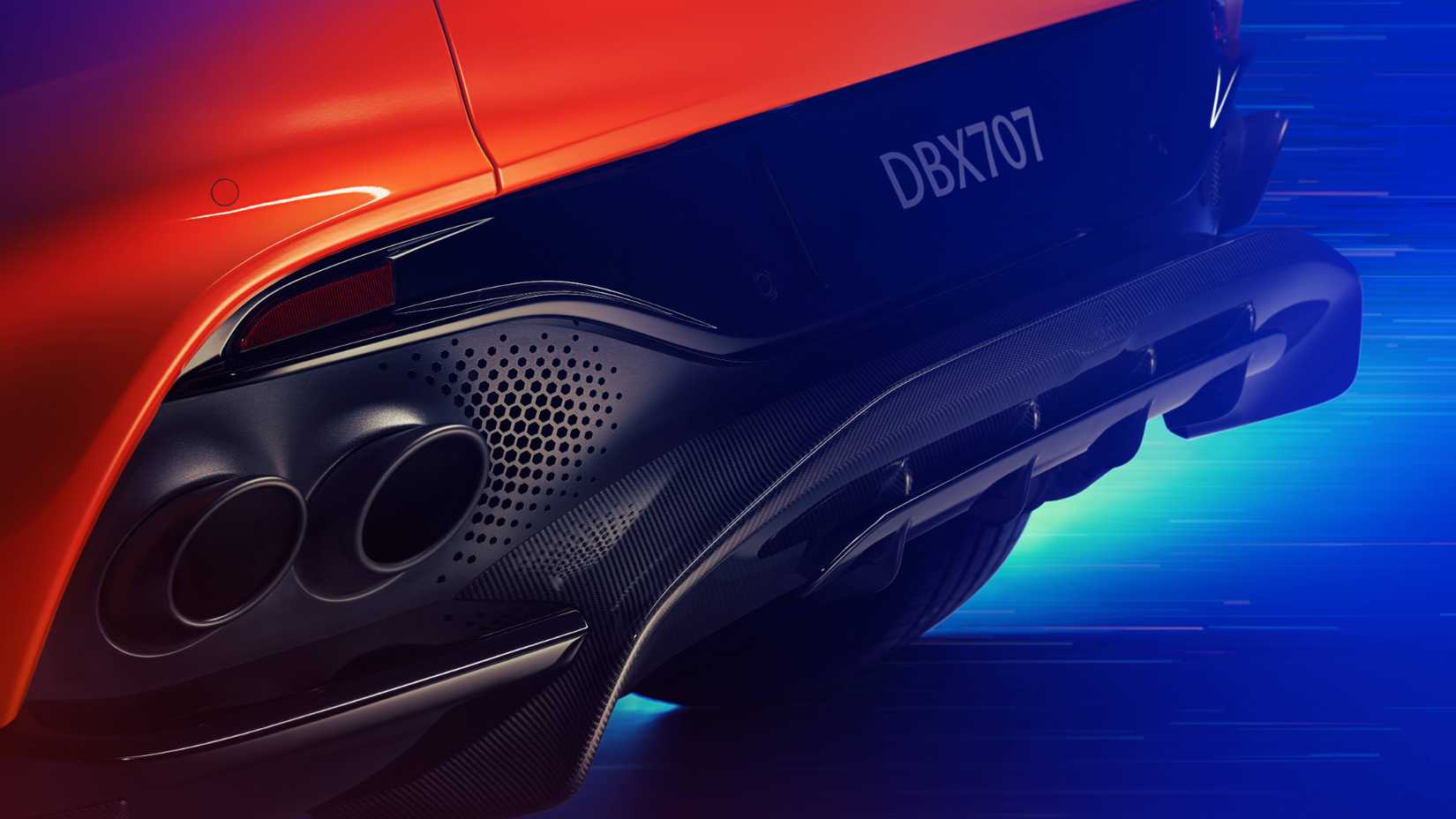 Close-up of the exhaust system and rear diffuser of a red 2025 Aston Martin DBX707.