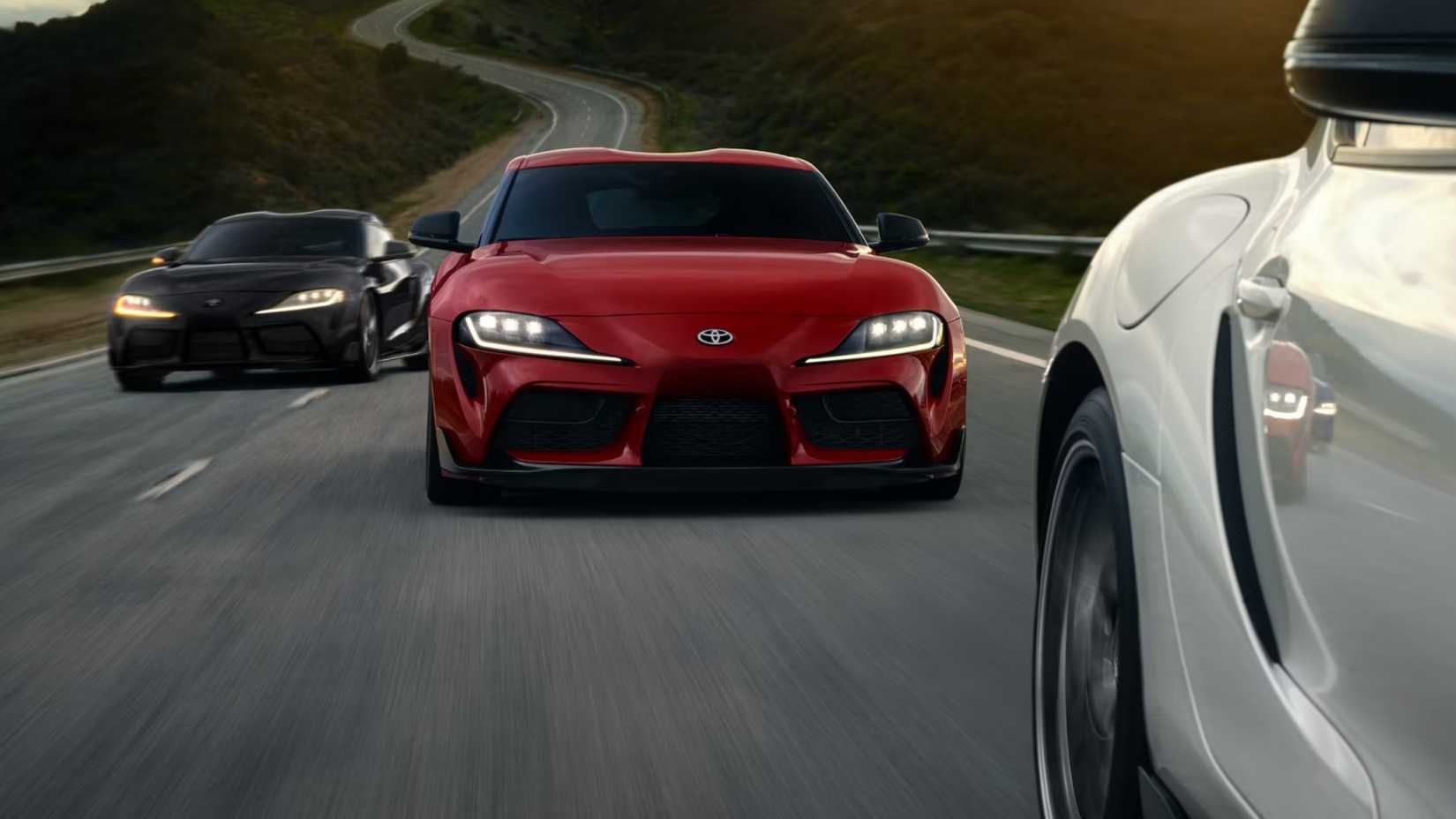 2025 Toyota GR Supra Trio Front White Red Black Driving on Track