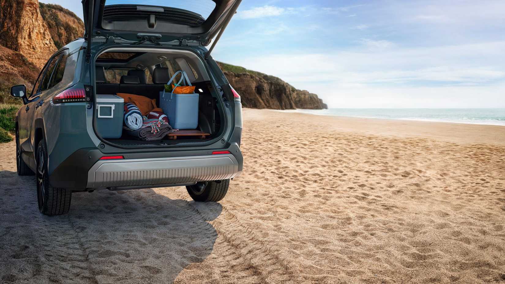 Shot of a 2026 Toyota RAV4 Limited with its trunk full of beach items.