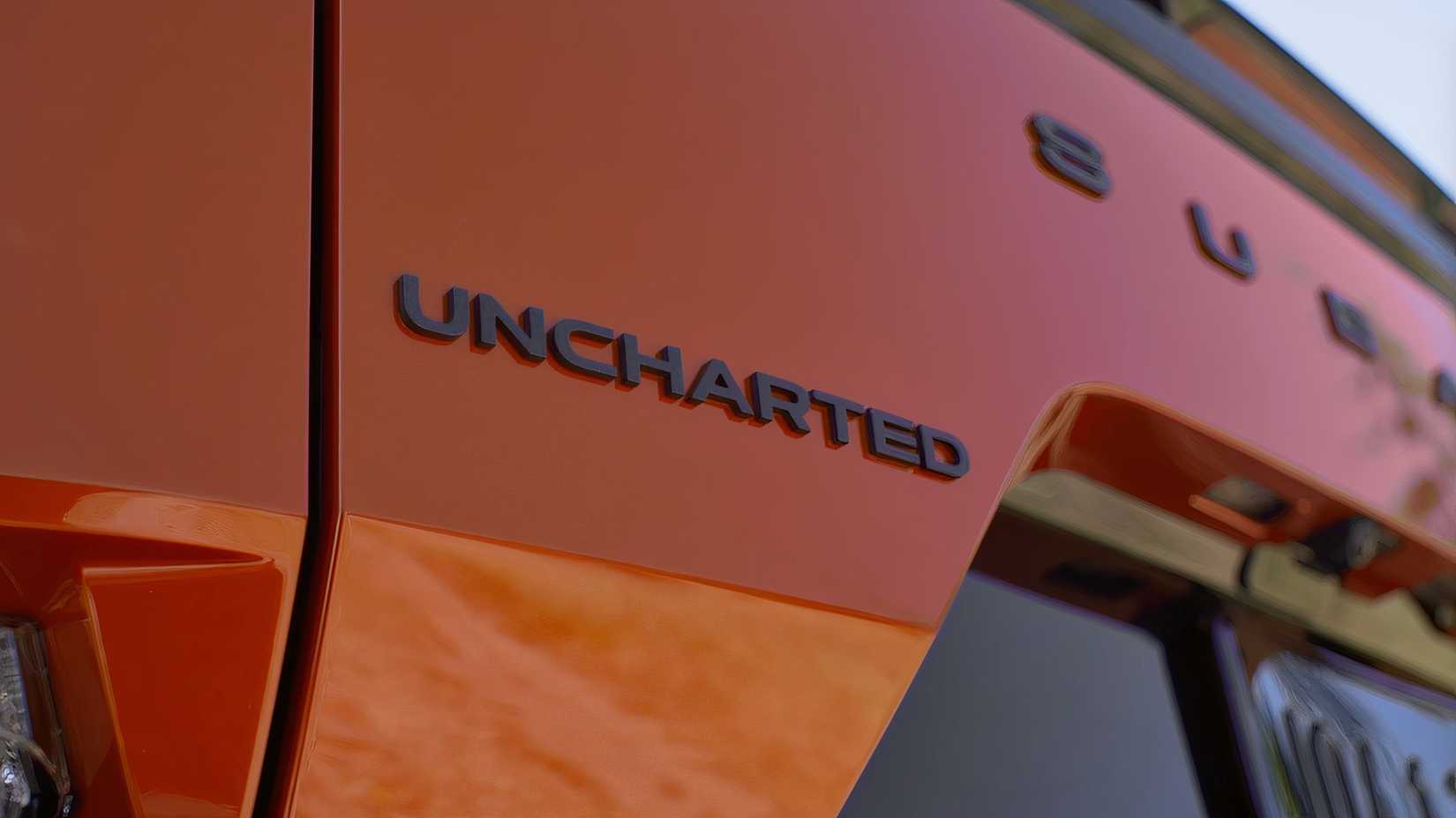 Close-up shot of the badging on the trunk lid of an orange 2026 Subaru Uncharted.