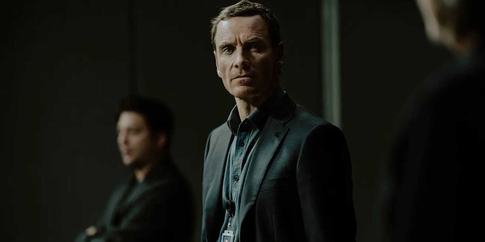 Michael Fassbender looks on in The Agency.