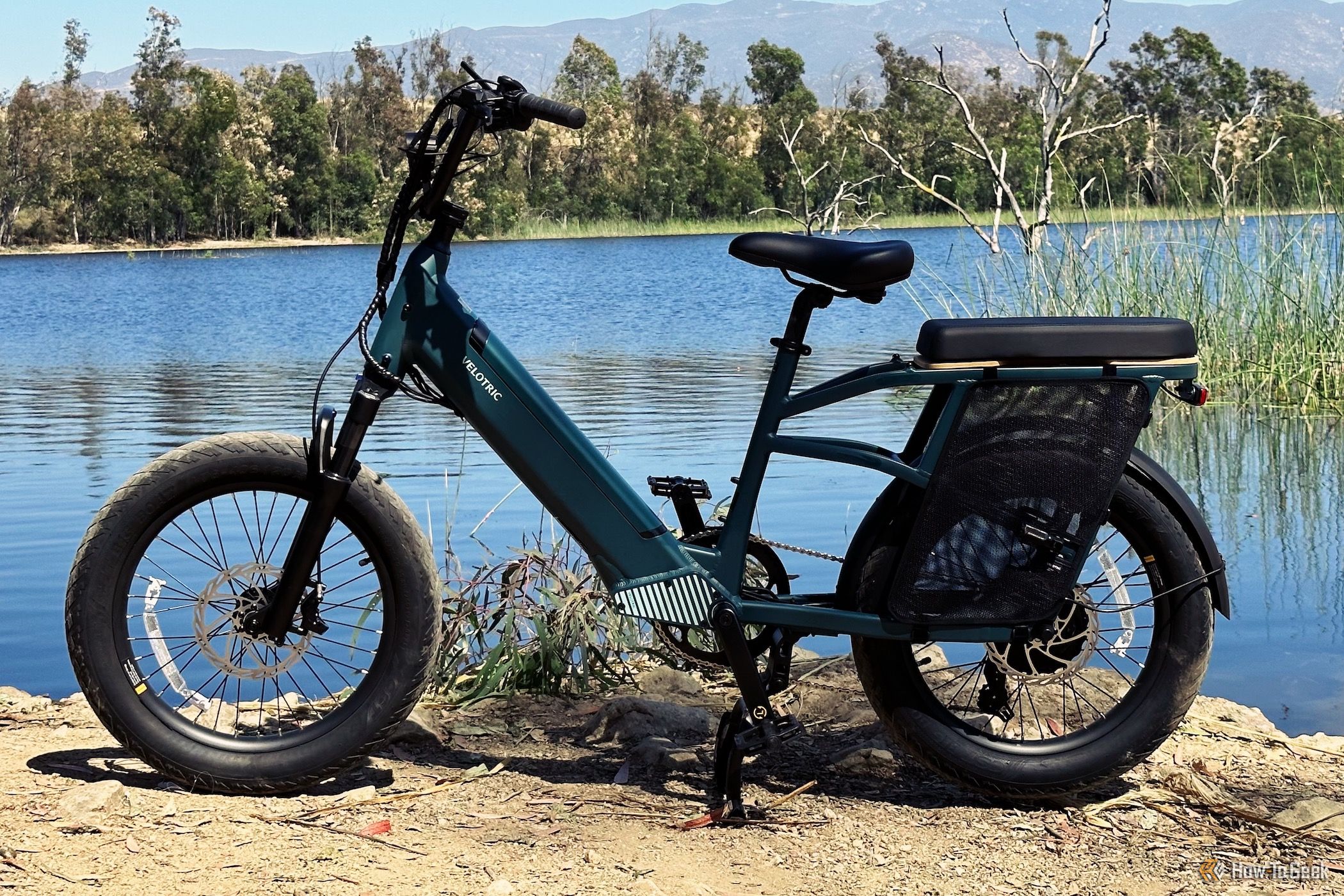 Velotric Go 1 stading in front of a lake