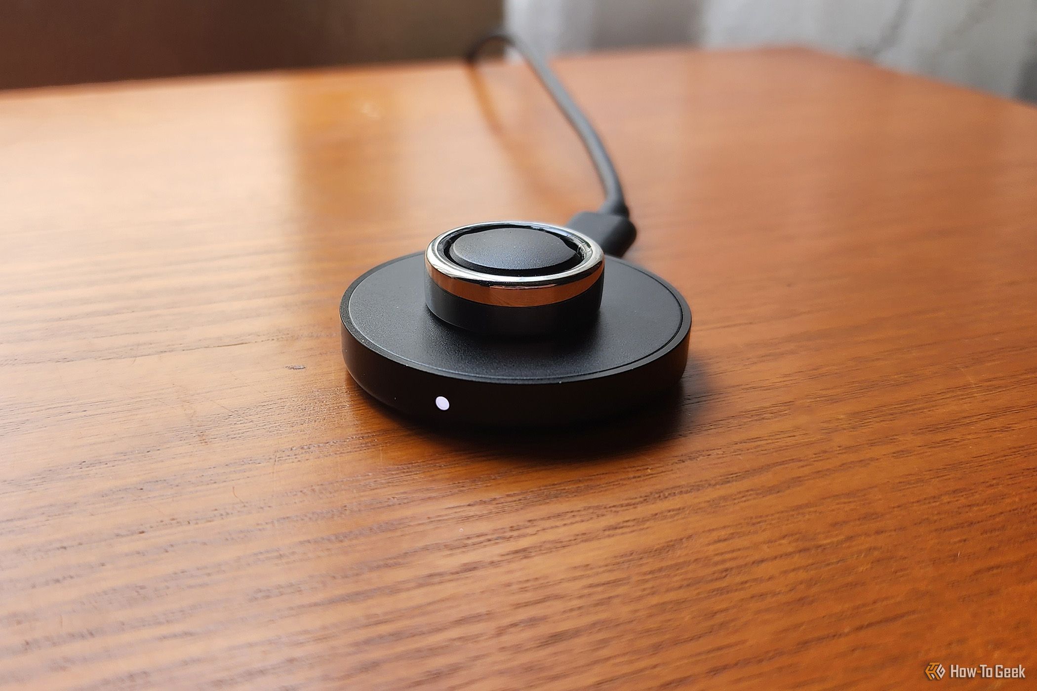 The 3rd Generation Oura Ring charging on its charger.