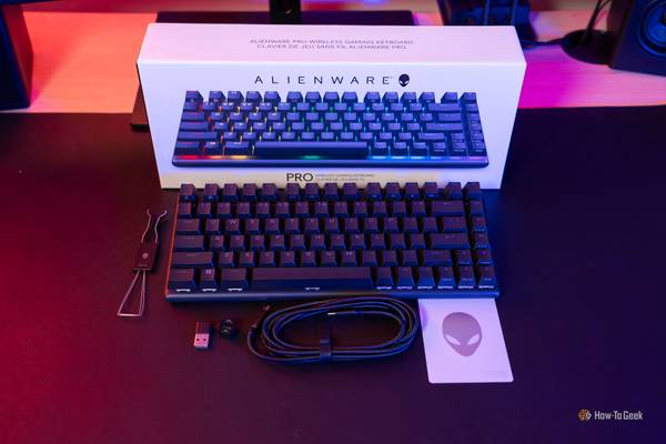 A black Alienware Pro Wireless Keyboard with box and accessories