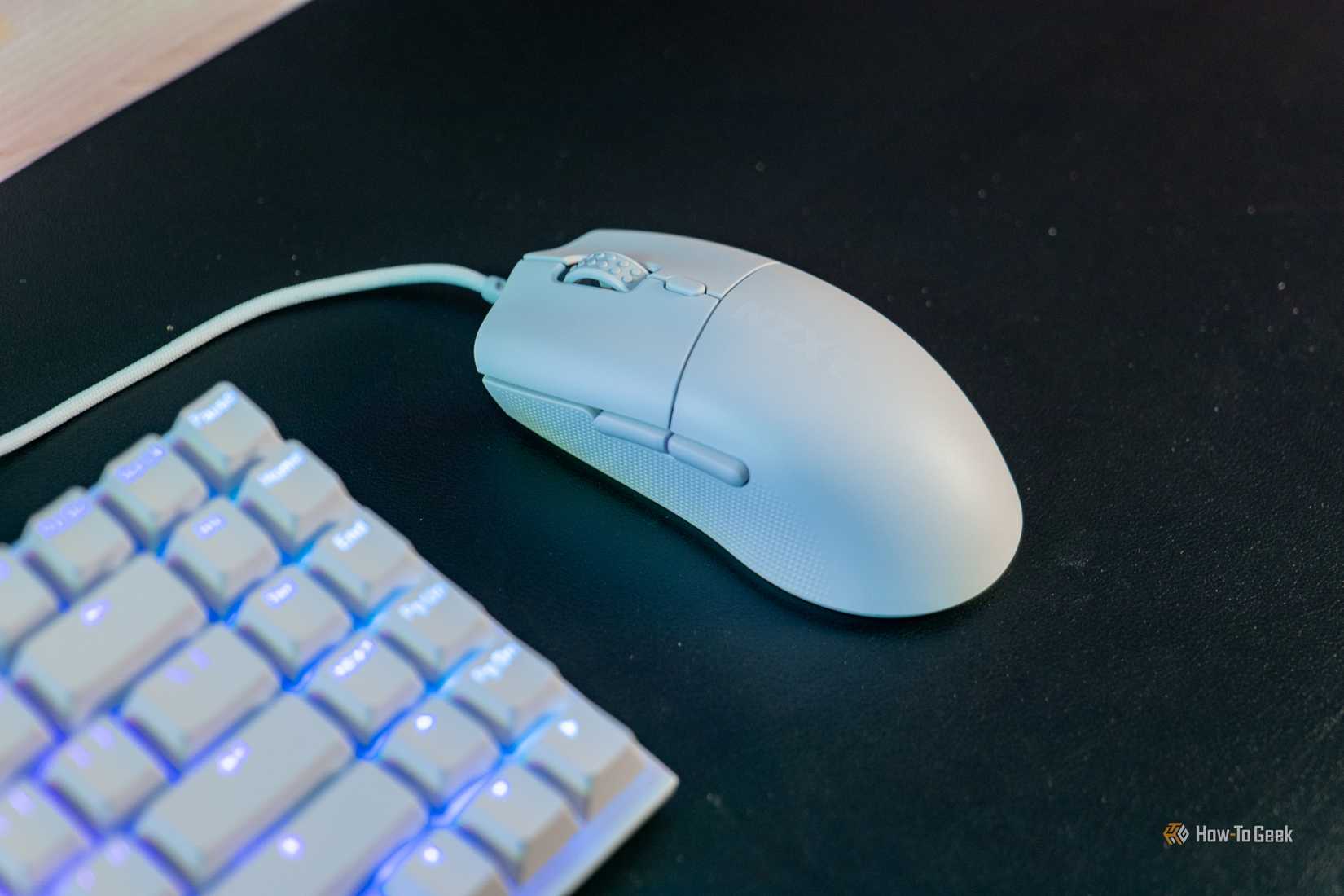 An angled view of the Lift 2 Ergo mouse next to a keyboard
