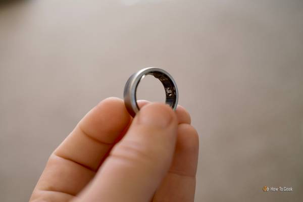 Oura Ring held in a hand