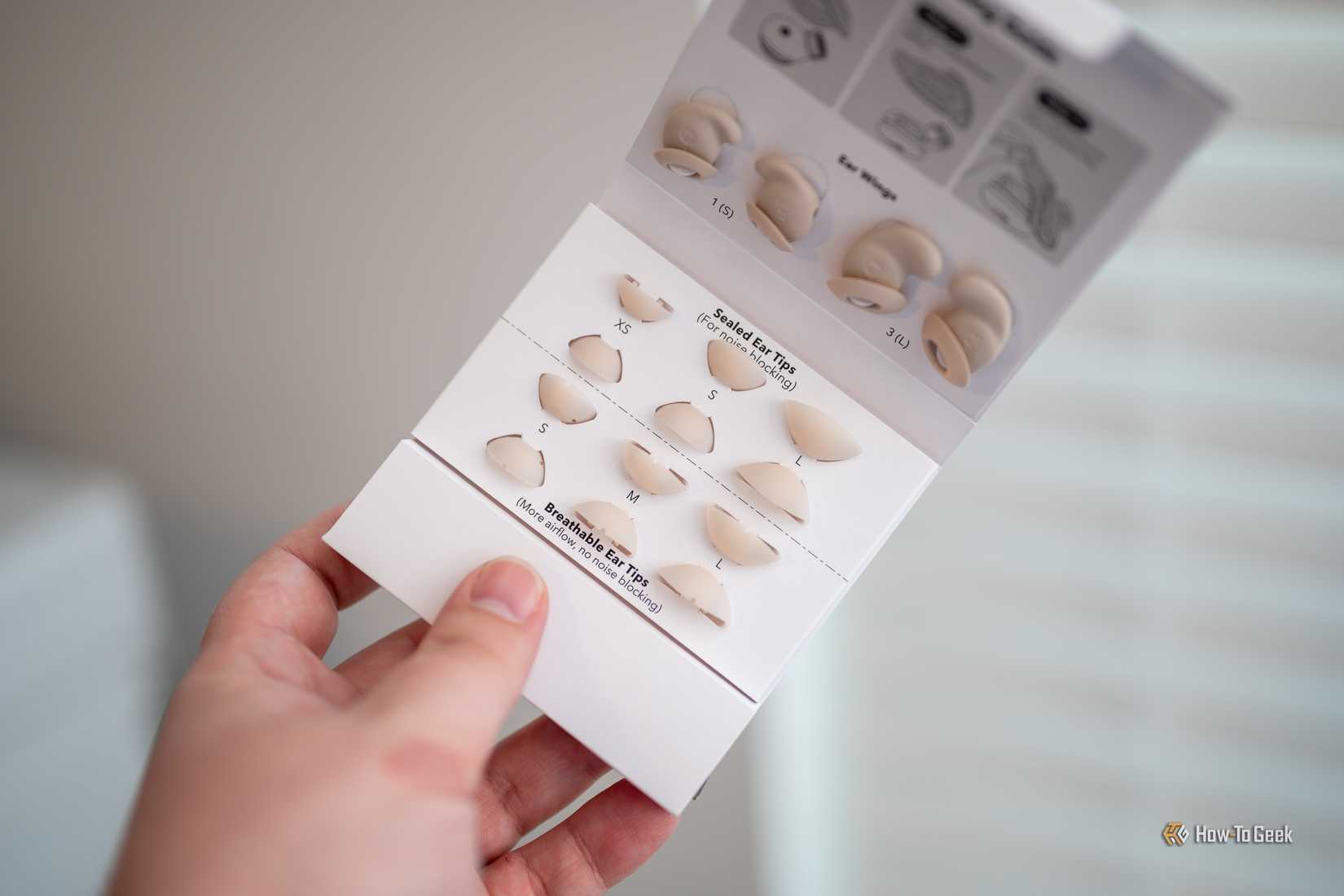 Person holding the Soundcore Sleep A20 Bluetooth Earbuds extra ear tips