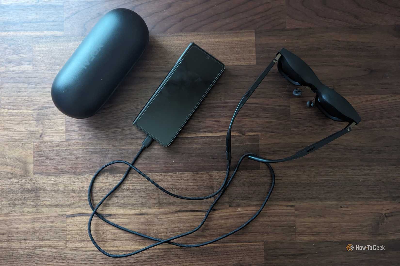 A Samsung Galaxy Z Fold 5, XREAL Air 2 Pro AR glasses, and a glasses case.