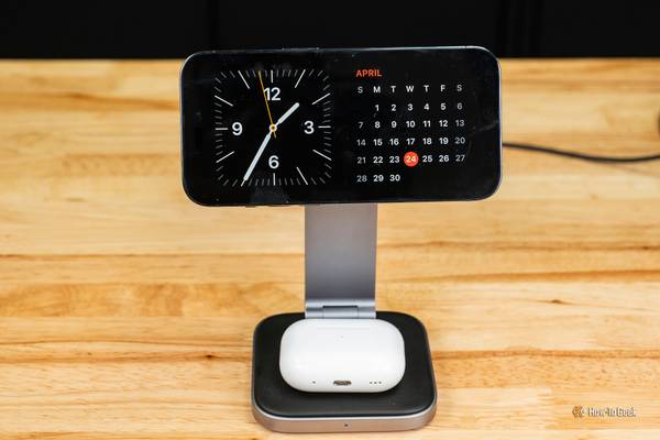 The Satechi 2-in-1 Foldable Qi2 Wireless Charging Stand charging an iPhone in landscape mode and Airpods