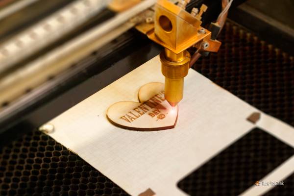 A laser machine engraving on wood.