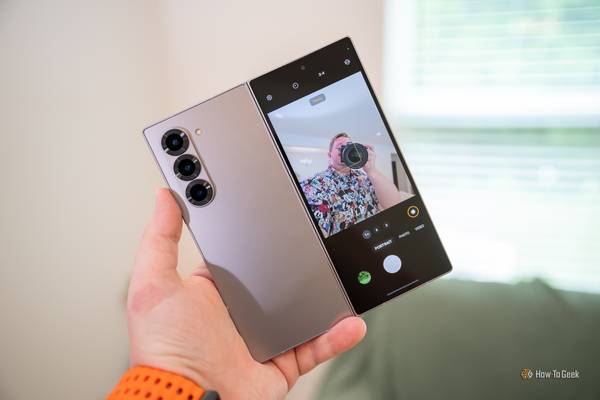 Person taking a selfie with the rear cameras and cover display on the Samsung Galaxy Z Fold 6