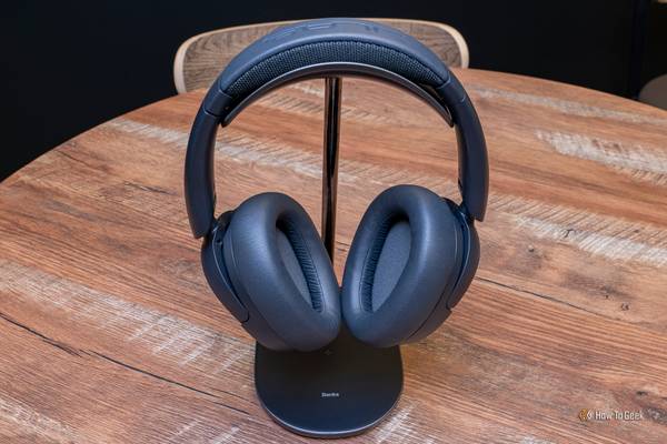 The JLab JBuds Lux ANC Wireless Headphones on a headphone stand