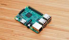 A Raspberry Pi 3 Model B sitting on a bamboo desk.