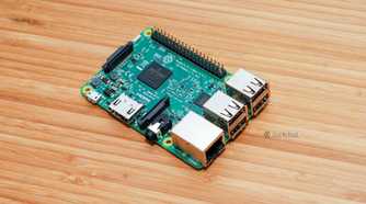 A Raspberry Pi 3 Model B sitting on a bamboo desk.