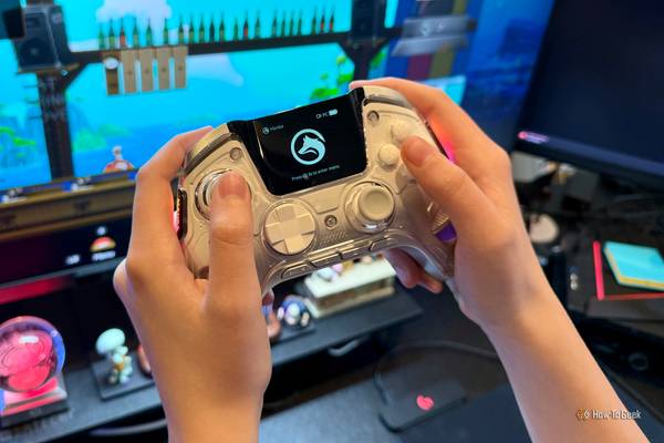 Manba One Game Controller being held in front of a computer screen