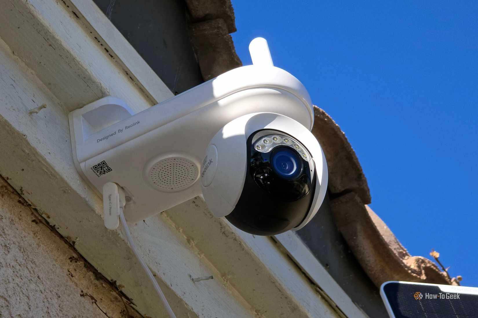 The Reolink Atlas PT Ultra security camera on the front of a house