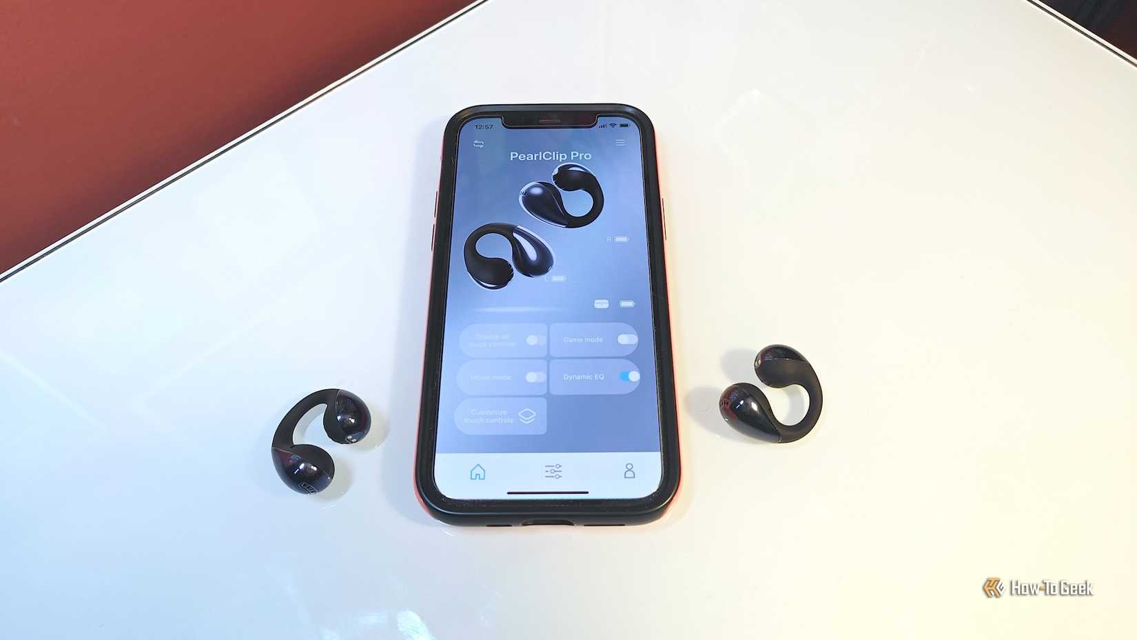 SoundPeats PearlClip Pro earbuds with smartphone displaying PeatsAudio app.