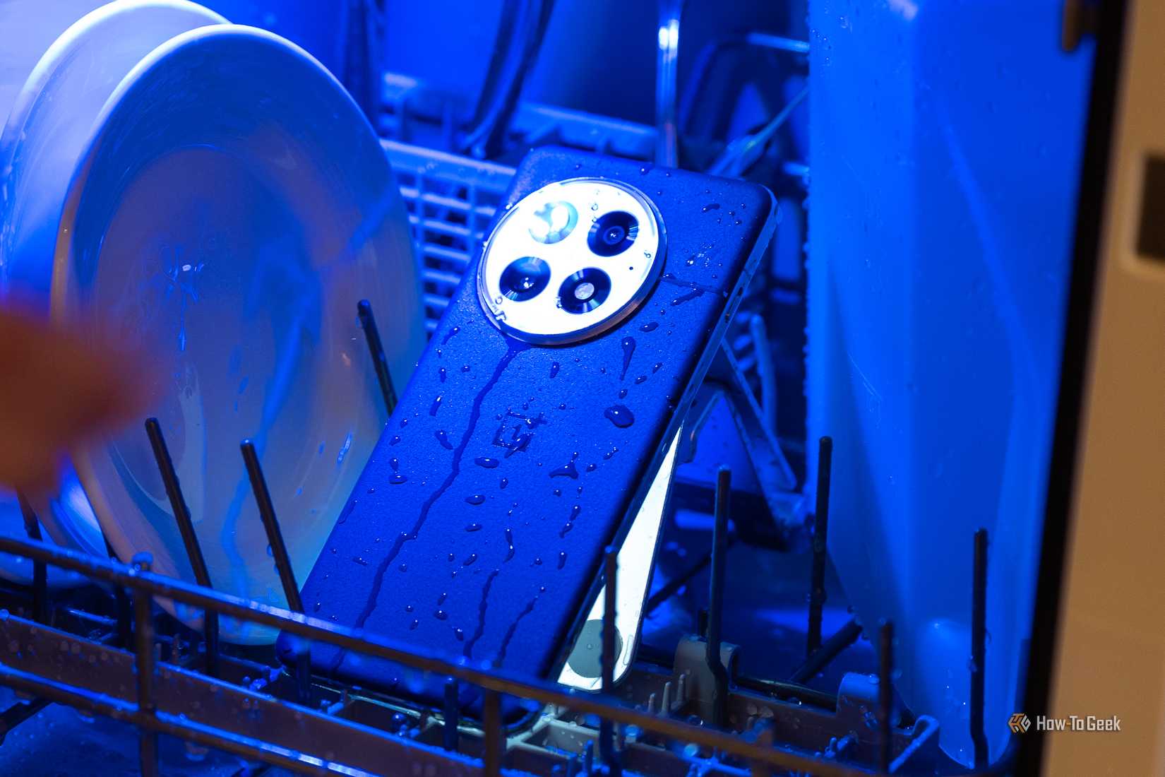 OnePlus 13 inside a dishwasher covered in water.