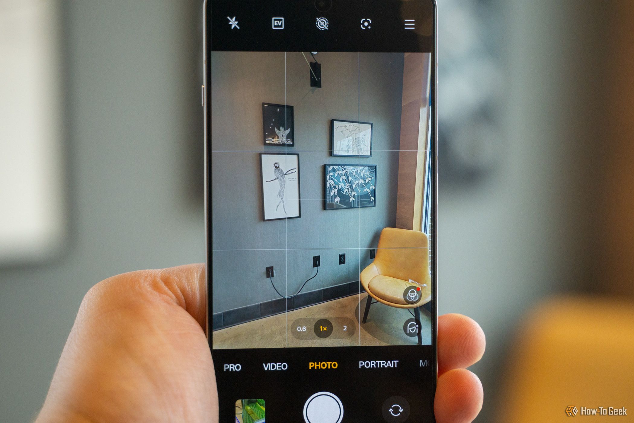 The OnePlus 13R camera app pointing at a wall of pictures.