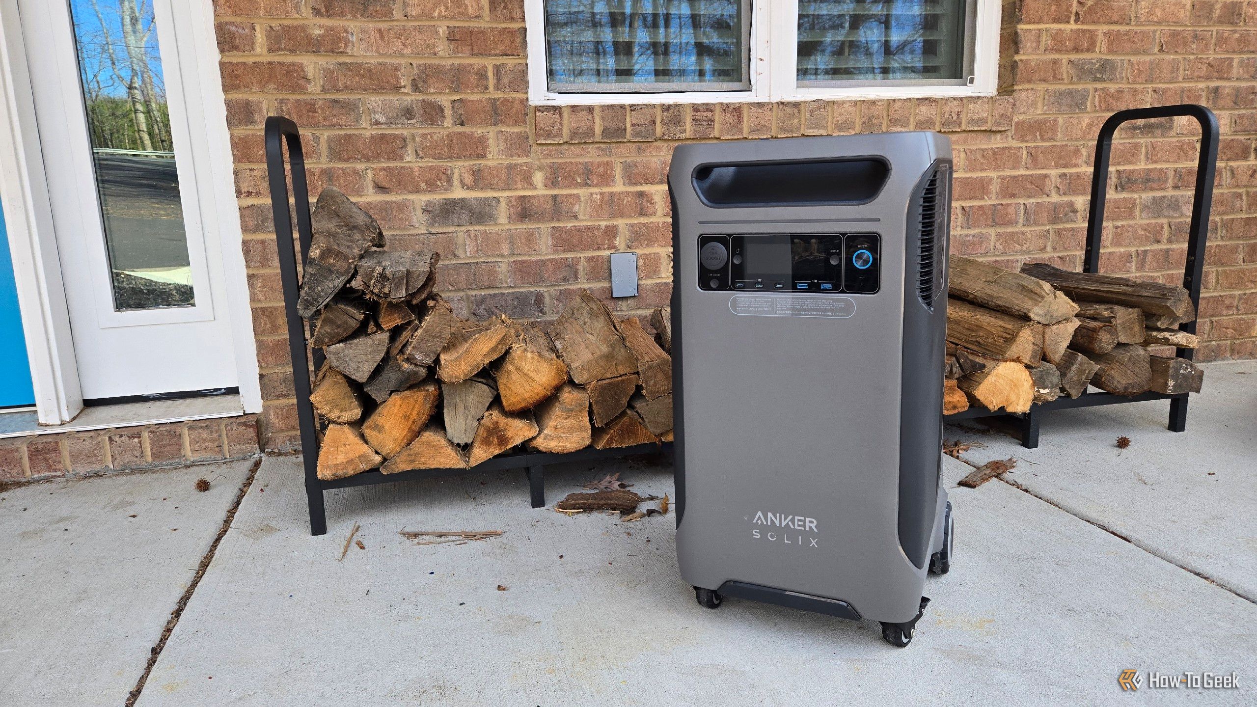 Anker F3800 portable solar generator in front of a firewood rack