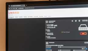 The Unraid dashboard opened on a computer monitor showing the logo and some server statistics.