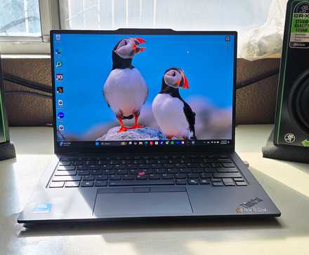 The Lenovo ThinkPad X1 Carbon Gen 13 Aura Edition laptop open on a desk.