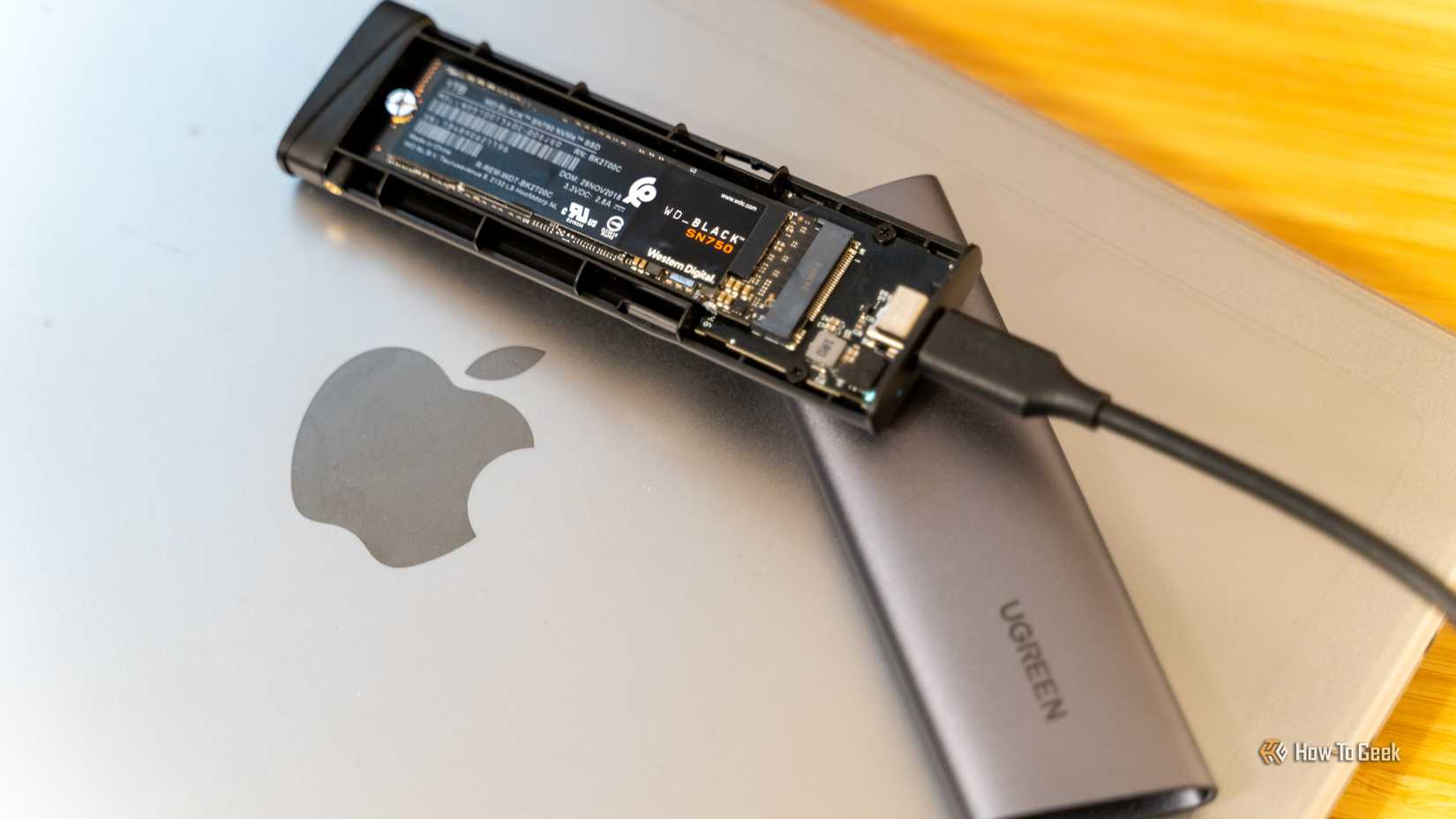 UGREEN M.2 NVMe SSD USB-C case with WD_BLACK SN750 SSD inside MacBook.