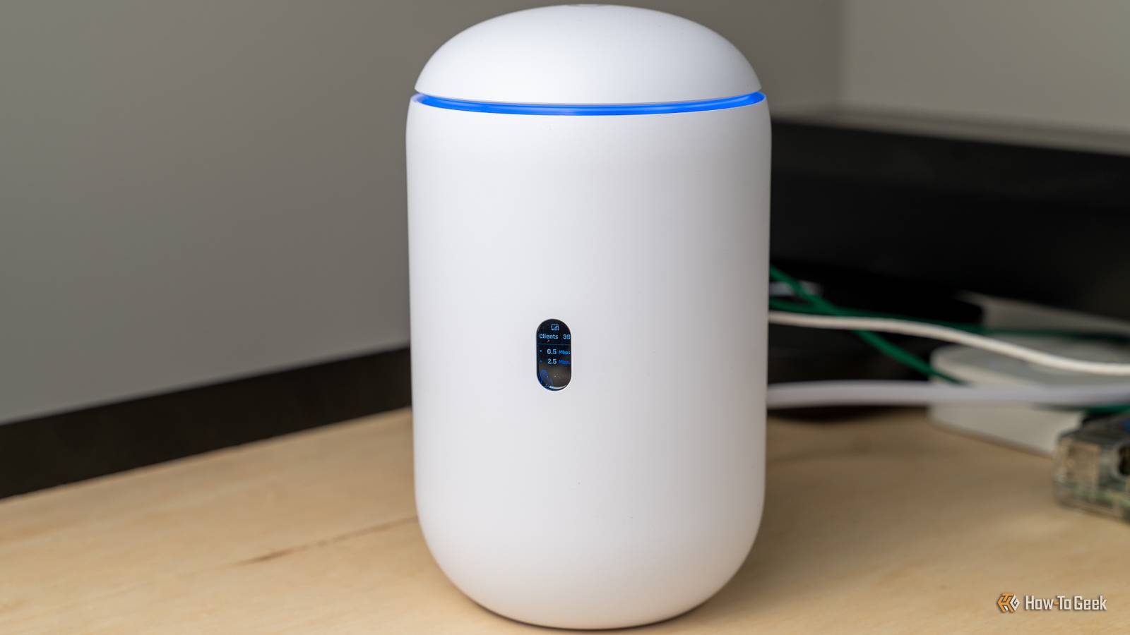 A front view of the Unifi Dream Router 7 with the screen visible.