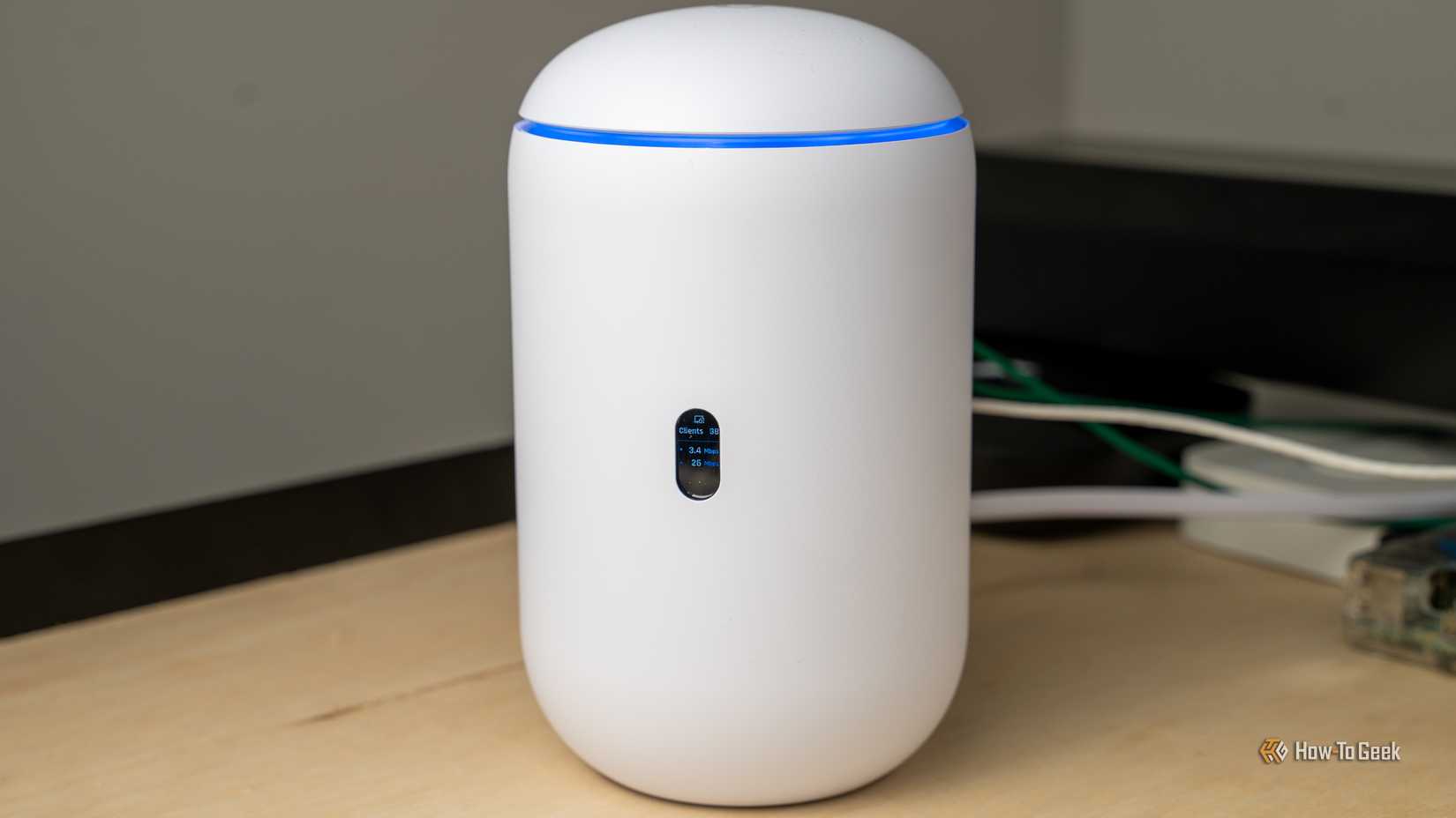 A front view of the Unifi Dream Router 7 with the screen visible.