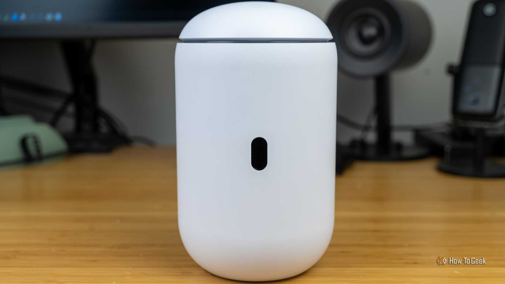 A front view of the Unifi Dream Router 7 with the screen visible but turned off.