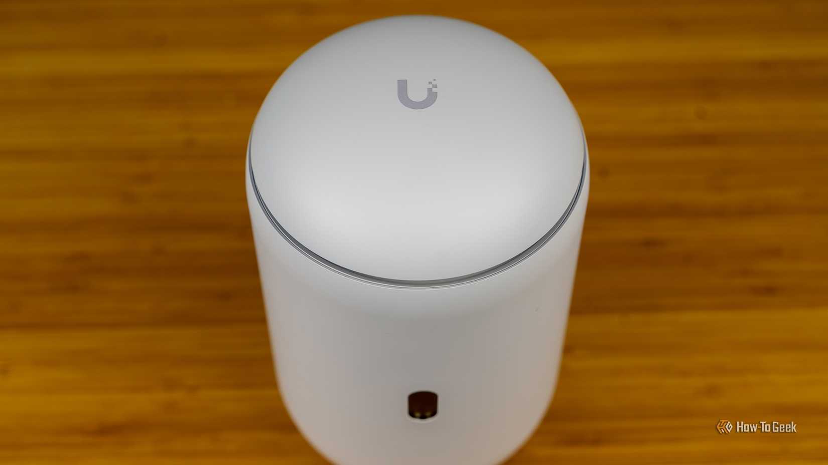 A top-down view of the Unifi Dream Router 7 with the Unifi logo visible.