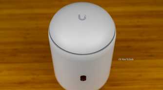 A top-down view of the Unifi Dream Router 7 with the Unifi logo visible.