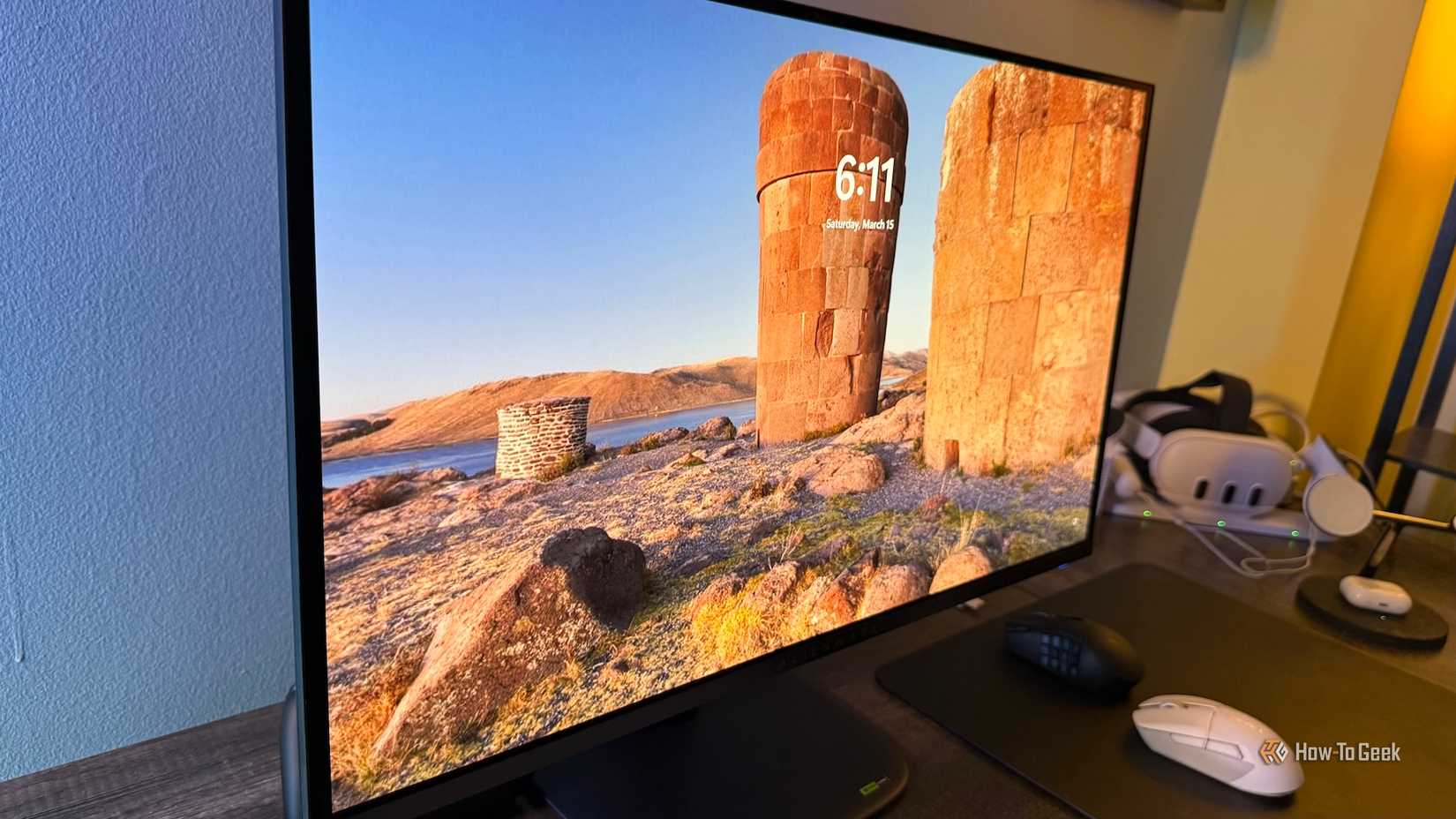 Windows login screen on an Alienware 27 4K QD-OLED (AW2725Q) at an angle.